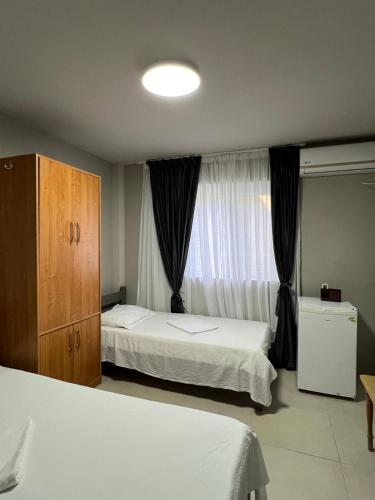 a hotel room with two beds and a window at Marald Eforie Nord in Eforie Nord