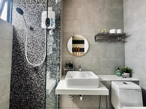 a bathroom with a sink and a shower at The Shore by D' Hannah Suite - Seaview in Kota Kinabalu
