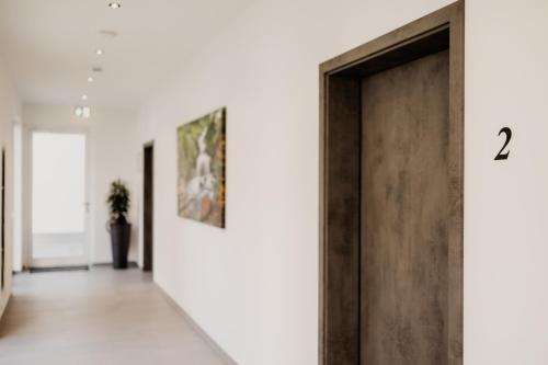 a hallway with a door with the number two at Heufeldboardinghouse in Kelheim