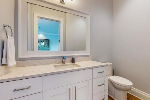 a white bathroom with a sink and a mirror at BrightWater Blue 158-2 in Clearwater Beach