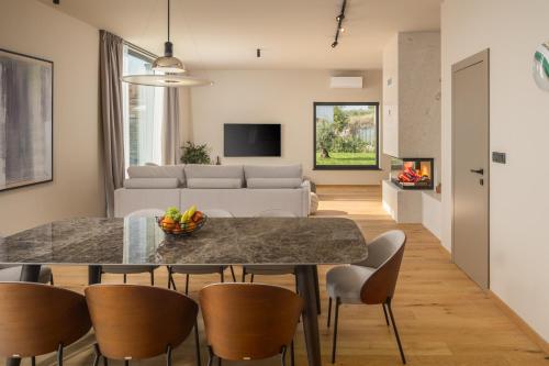a kitchen and living room with a table and chairs at Design Villa Istar in Bale