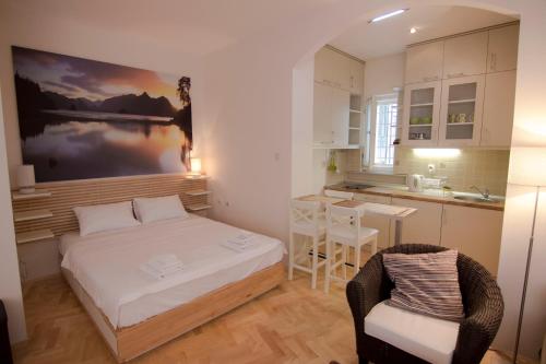 a small bedroom with a bed and a kitchen at Apartment Dositej 3 in Belgrade