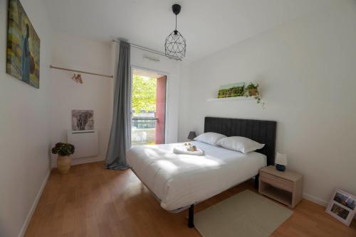 une chambre avec un lit blanc et une fenêtre dans l'établissement La Vilaine, à Rennes