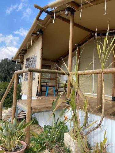 a porch of a house with a wooden deck at למדבר- חווית גלמפינג במדבר in Arad