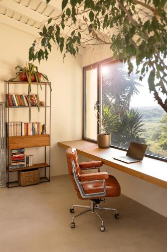 an office with a desk and a chair and a window at Sobral Serenity Villa in Amoreira