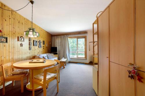 a living room with a table and a room with a couch at Casa Franco - Pila Appartamenti in Pila