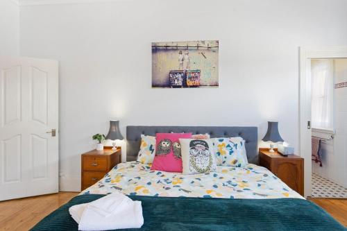 a bedroom with a bed with colorful pillows at 4-Bed 3-Bath Sunset Haven in Sunset Strip