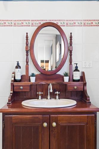 a bathroom with a sink and a mirror at 4-Bed 3-Bath Sunset Haven in Sunset Strip