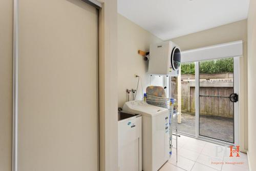 a kitchen with a refrigerator and a microwave at Cowes 3Bdr-2Bt Family TownHouse in Cowes