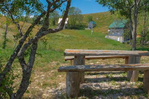 a wooden bench sitting on top of a hill at 4NORTH Apartment17 in Pluzine