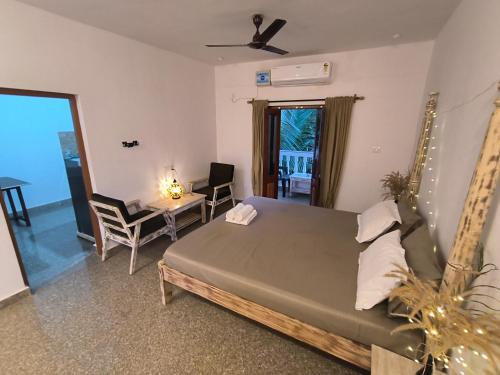 a bedroom with a bed and a table and chairs at SHANKAR by the SEA, 2 min from Mandrem Beach in Mandrem