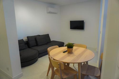 a living room with a table and a couch at Alojamento Fortaleza in Valença