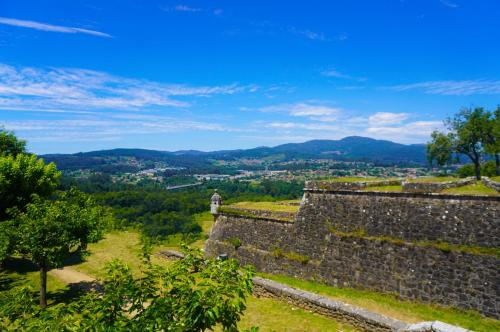 a person standing on top of a wall with a view at Alojamento Fortaleza in Valença
