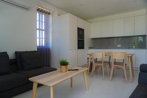 a living room with a couch and a table at Alojamento Fortaleza in Valença