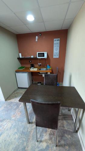 an empty office with a table and chairs in a room at Tres Arroyos Studio in Tres Arroyos