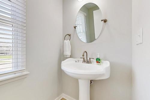 a white bathroom with a sink and a mirror at Turtle #21B-CAC in Buxton
