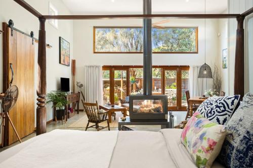 a living room with a bed and a fireplace at The Ancient Mariner Retreat in Cape Woolamai