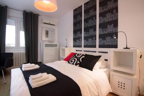 a bedroom with a bed with two towels on it at Apartment Madera in Belgrade