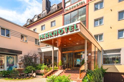 a hotel with a sign on the front of it at Parkhotel Crombach in Rosenheim