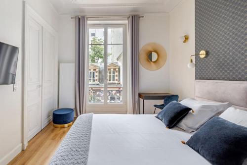 une chambre avec un lit blanc et une fenêtre dans l'établissement Newly renovated apt near La Madeleine, à Paris