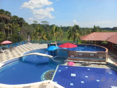 a large swimming pool with blue tiles on it at Finca la Margarita in Cumaral