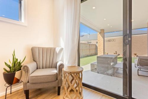 a living room with a chair and a fireplace at Modern Family-Friendly Getaway 4-Bdr 2 Bath in Cowes
