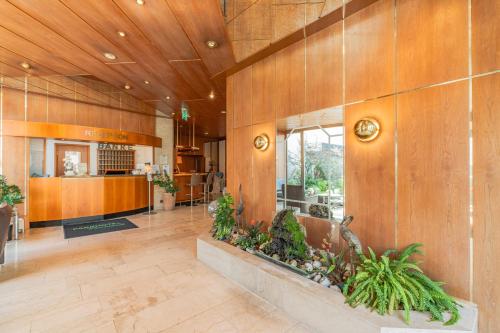 a lobby of a building with wooden walls at Parkhotel Crombach in Rosenheim