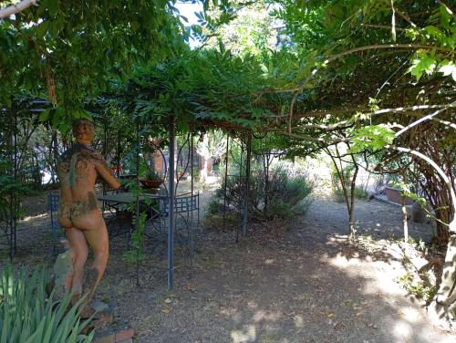 a statue of a naked woman sitting at a table at MARIA HOLIDAY HOMES La Pineta di Sinalunga in Sinalunga