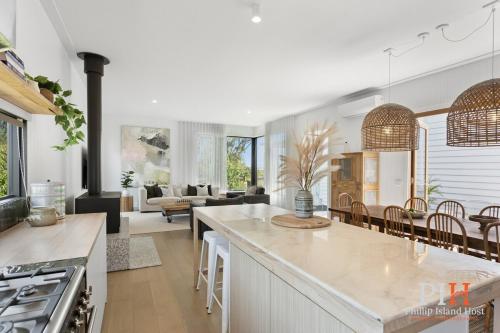a kitchen and living room with a counter and chairs at Charming 4 BR Cottage Retreat in Newhaven