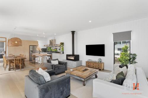 a living room with two couches and a tv at Charming 4 BR Cottage Retreat in Newhaven