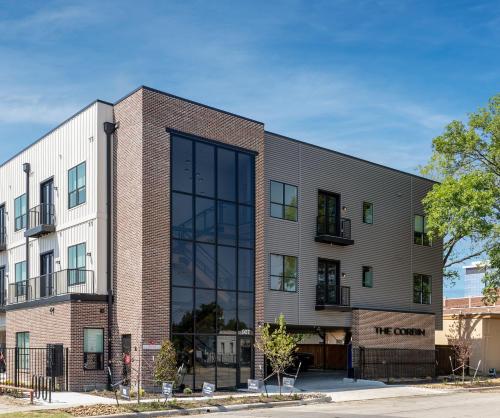 a large brick building with glass windows at The Corbin 1101 - Magnolia Haven in Fort Worth