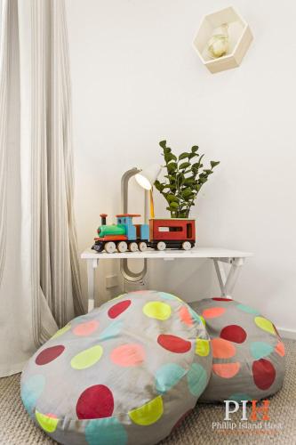 a table with a toy train on top of a cushion at Smith Beach Family House Sleep 6 in Smiths Beach