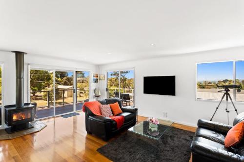 a living room with two couches and a fireplace at Ocean View Escape w 3BR & 2BA in Rhyll