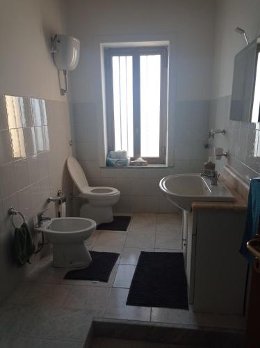 a bathroom with two toilets and a sink at Hostel Murphy in Scafati