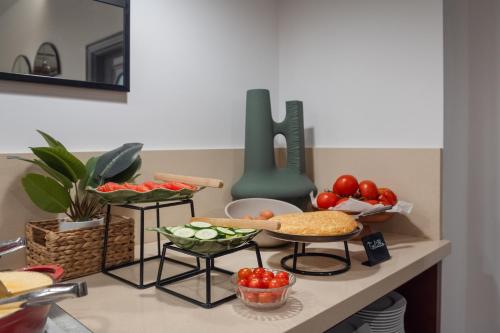 a counter top with a bunch of food on it at Hotel Santiago Plaza Affiliated by Meliá in Santiago de Compostela