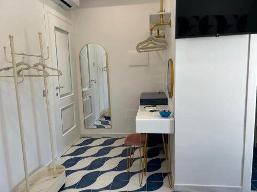 a bathroom with a blue and white checkered floor at Blu D Alia Exclusive Rooms in Ischia