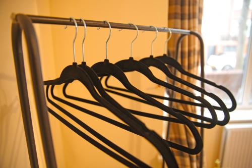 a group of hoses hanging on a rack at Ensuite Near Luton Station in Luton