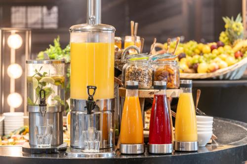 a buffet with many different types of drinks on a table at Mercure Le Mans Centre in Le Mans