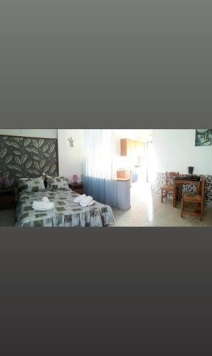 a bedroom with two beds and a table in a room at Studio Poseidon in Lipsoi