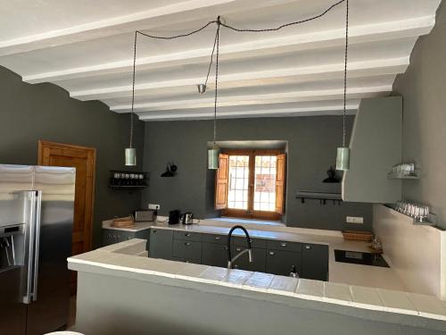 a kitchen with a white ceiling and a sink at Can Casellas in Palau Sator