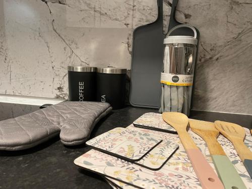 a table with a napkin and utensils on a counter at Serenity Luton Suite Near Mall in Luton