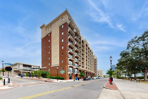 a tall brick building on a city street with a road at River View Condo 602 & 603 in Wilmington