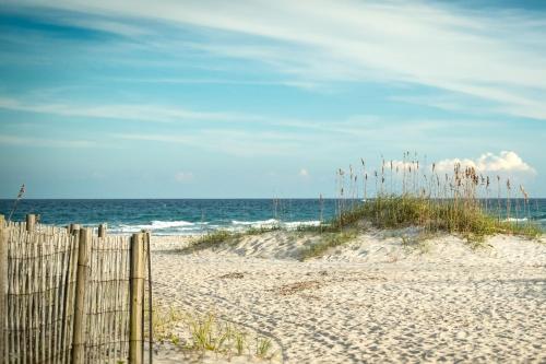 a wooden fence on a beach near the ocean at River View Condo 602 & 603 in Wilmington