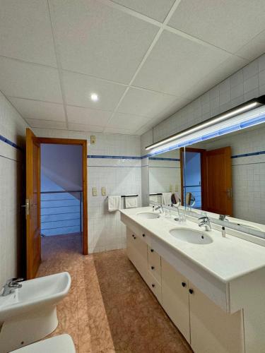a bathroom with two sinks and a large mirror at N28 in Xàtiva