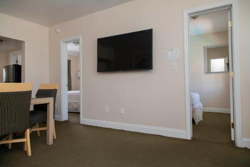 a living room with a flat screen tv on a wall at Beach Place Hotel in Miami Beach