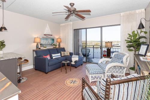 a living room with a blue couch and chairs at River View Condo 602 & 603 in Wilmington
