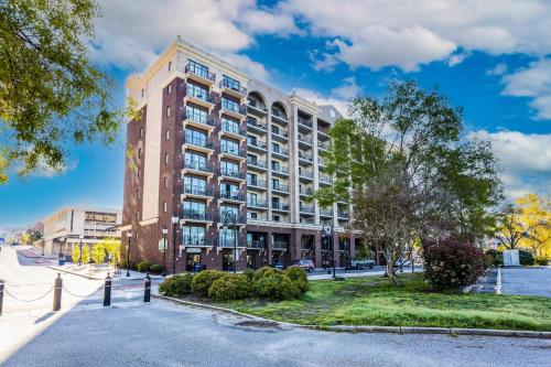 a tall building on a city street with trees at River View Condo 602 & 603 in Wilmington