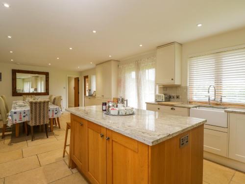 a kitchen with a island in the middle of a room at Lower Farm Barn in Oxford