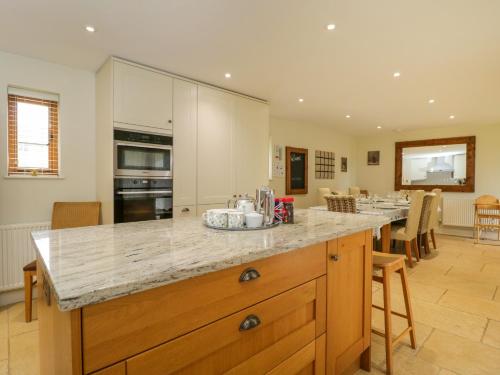 a kitchen with a large island with a counter top at Lower Farm Barn in Oxford