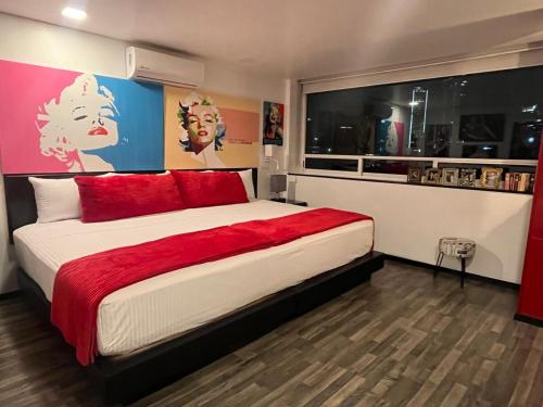 a bedroom with a large bed with red pillows at Hotel Black Boutique in Mexico City